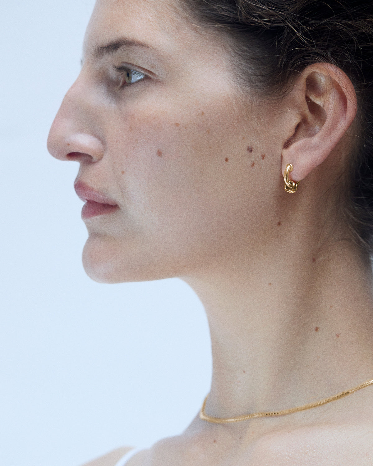 Model wearing Laura Lombardi gold Mini Fillia Earrings
