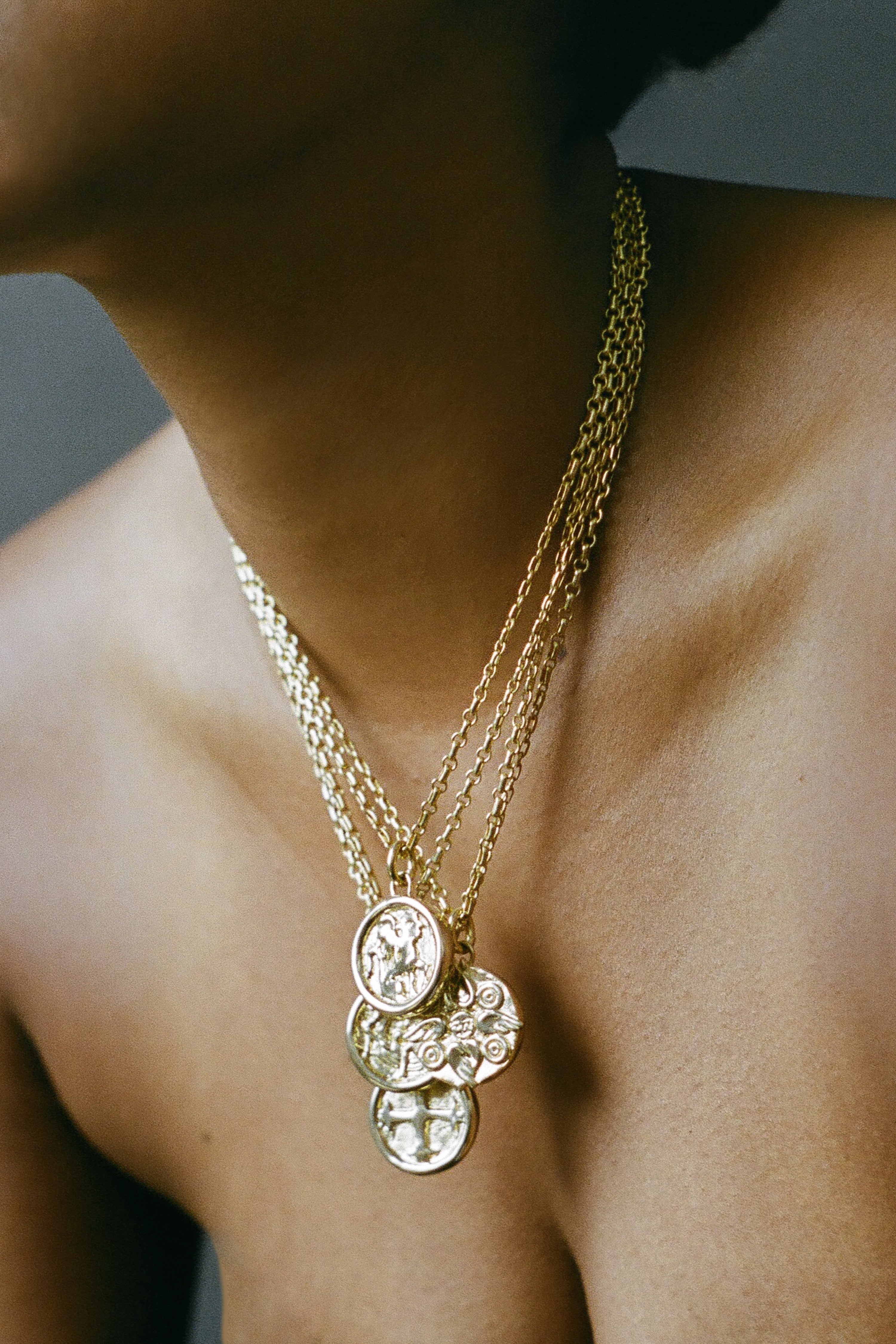 Model wearing AMS x LL gold Seraphim Pendant