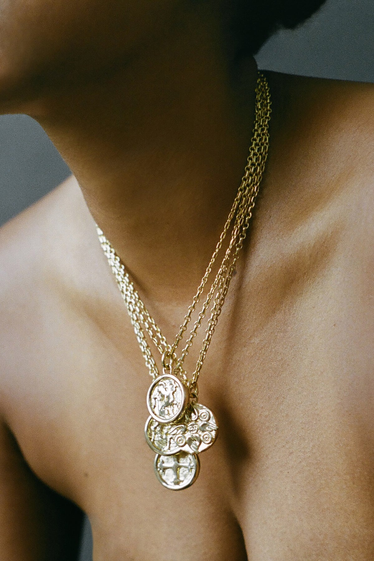 Model wearing AMS x LL gold Seraphim Pendant