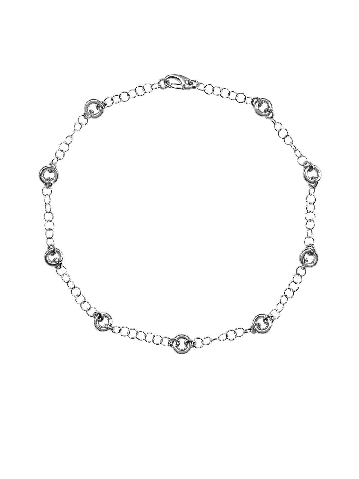 The Astra Necklace, a delicate cable chain with circular link accents in silver.