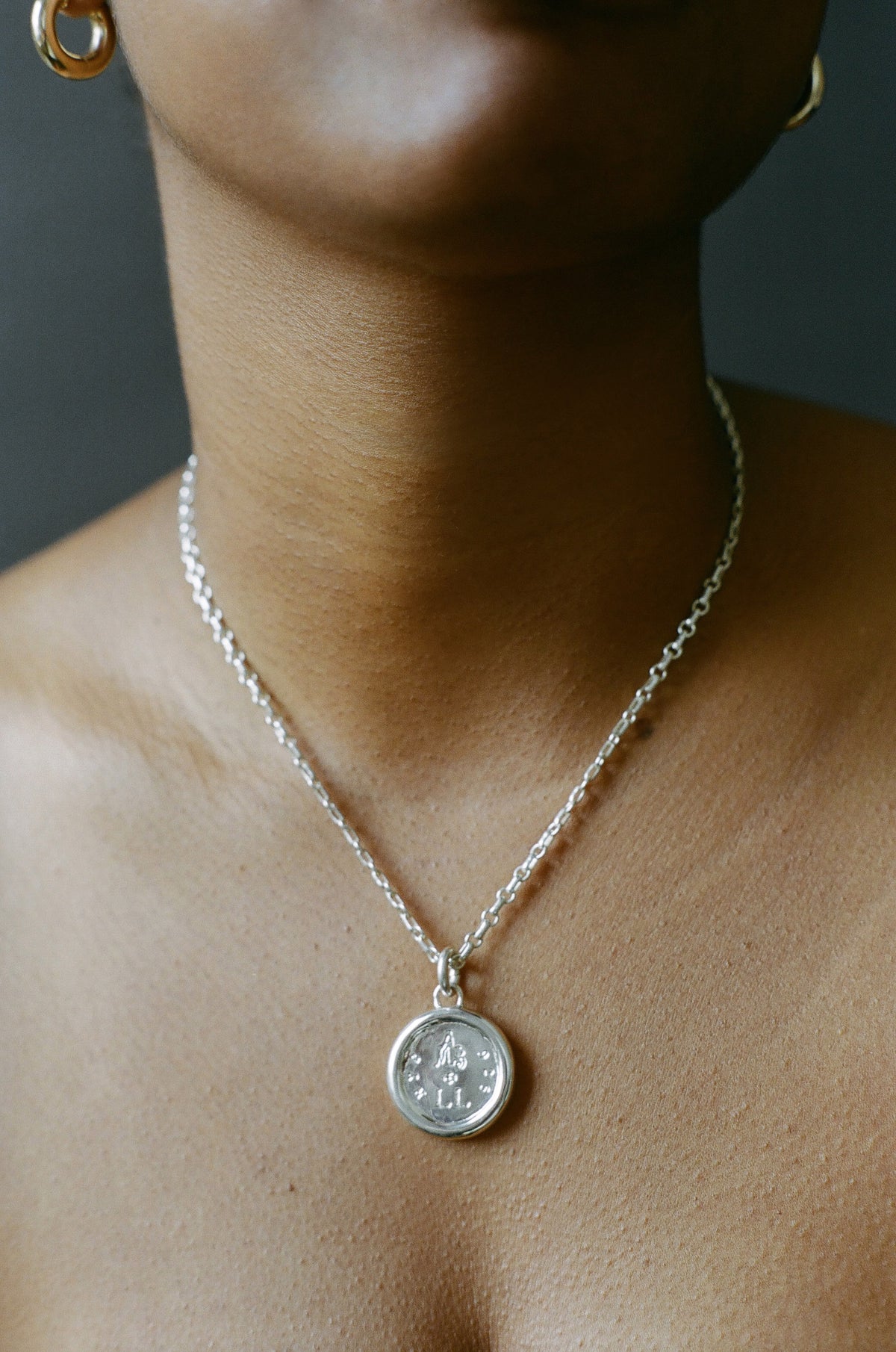 Model wearing AMS x LL Silver Seraphim Pendant
