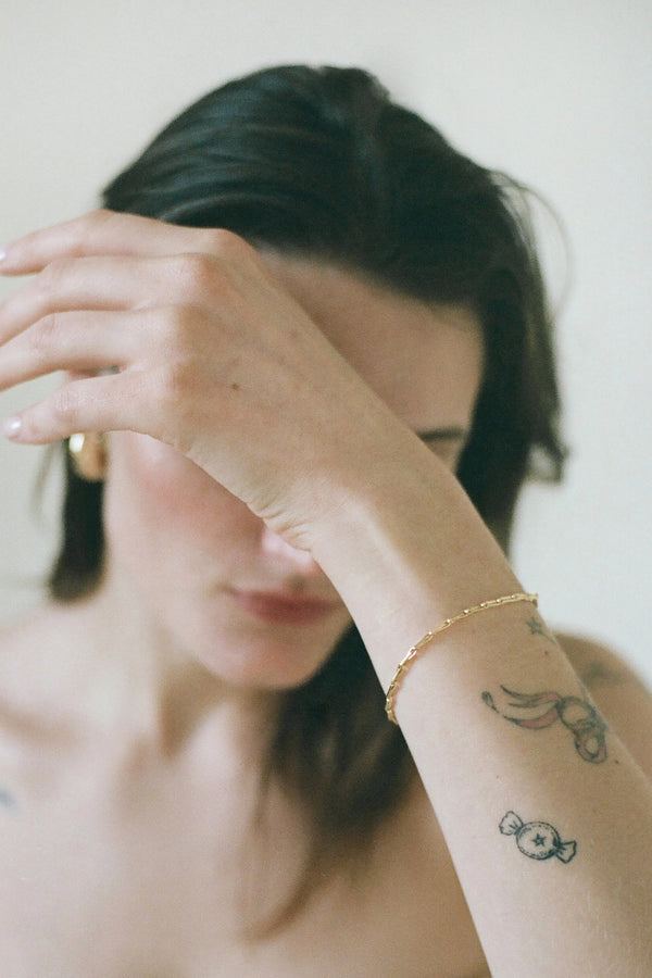 Model wearing Laura Lombardi gold Corre Bracelet