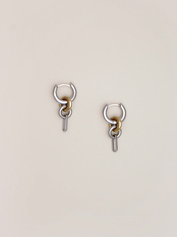 A pair of Two Tone Frena Earrings, silver hoop earrings with a dangling gold and silver chain link design, shown on a neutral background.