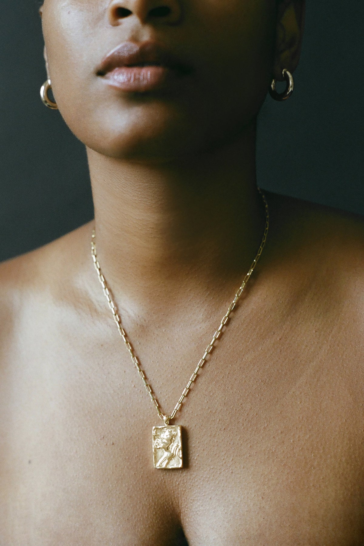Model wearing AMS x LL gold Leonne Pendant