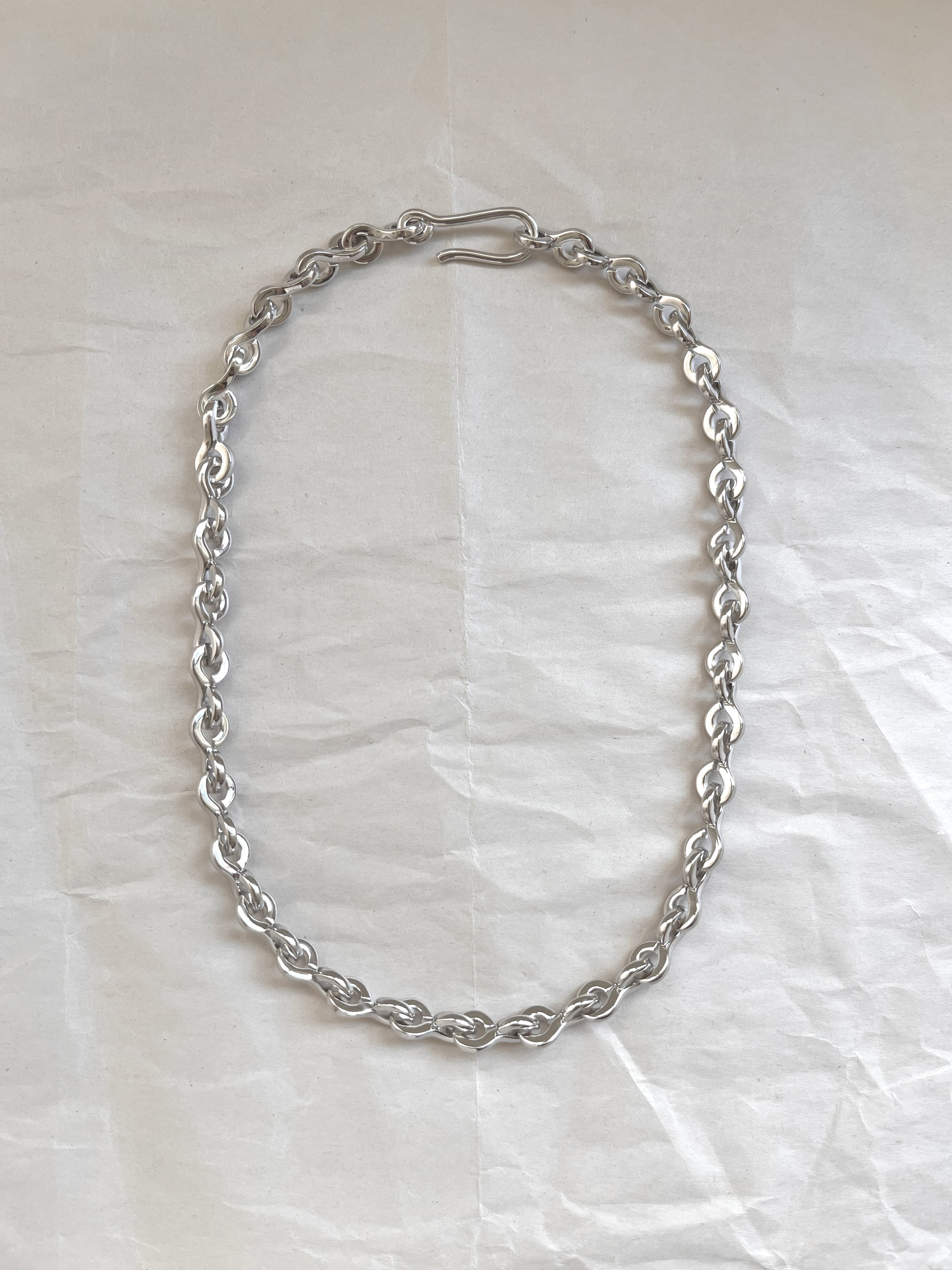 Laura Lombardi Silver Nuova chain necklace on a white paper background.