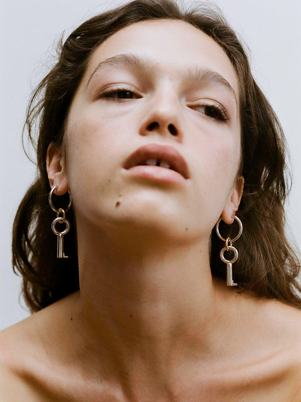 Close-up portrait of model wearing the Two Tone Permesso Earrings.