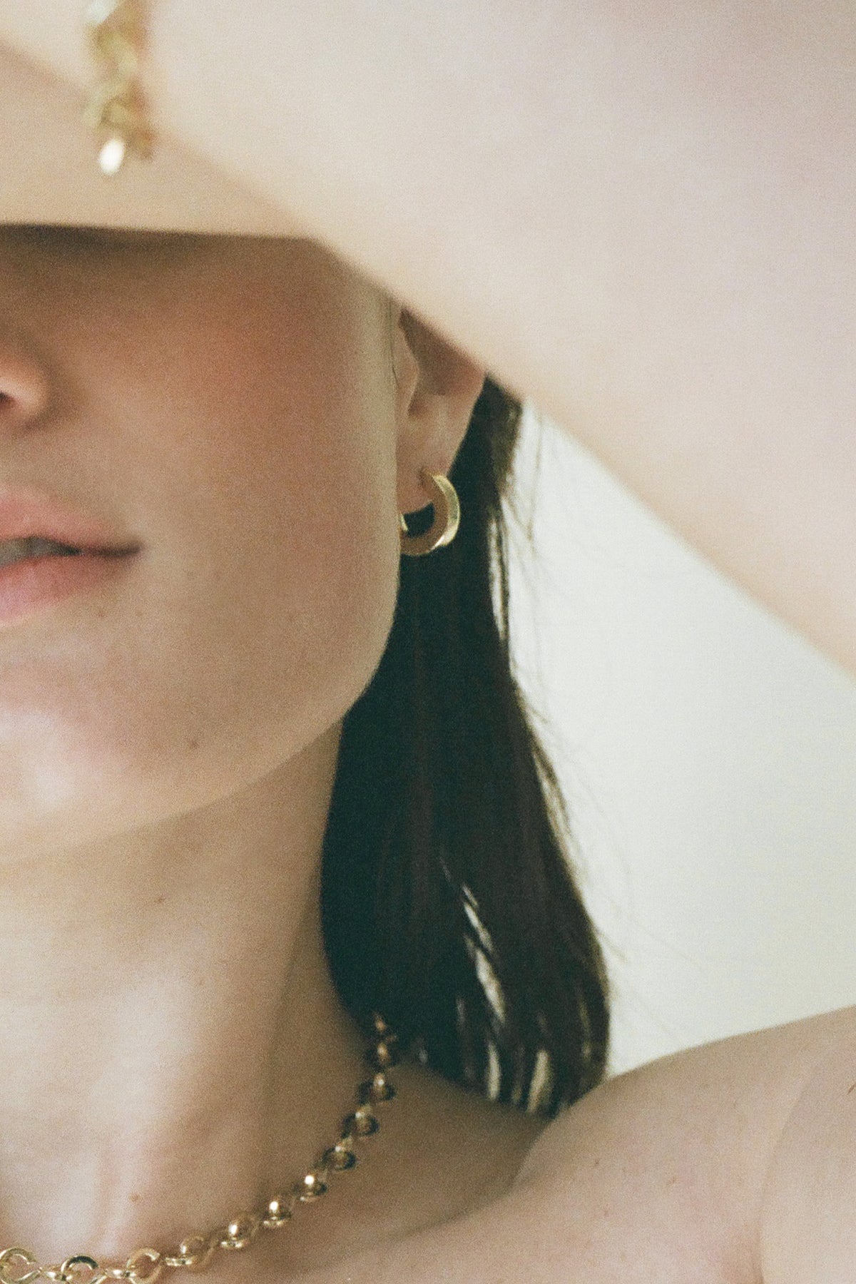 Model wearing Laura Lombardi gold Persa Earrings