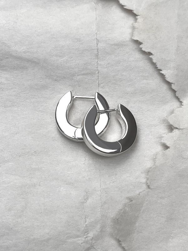 Laura Lombardi Silver Persa Earrings on paper background