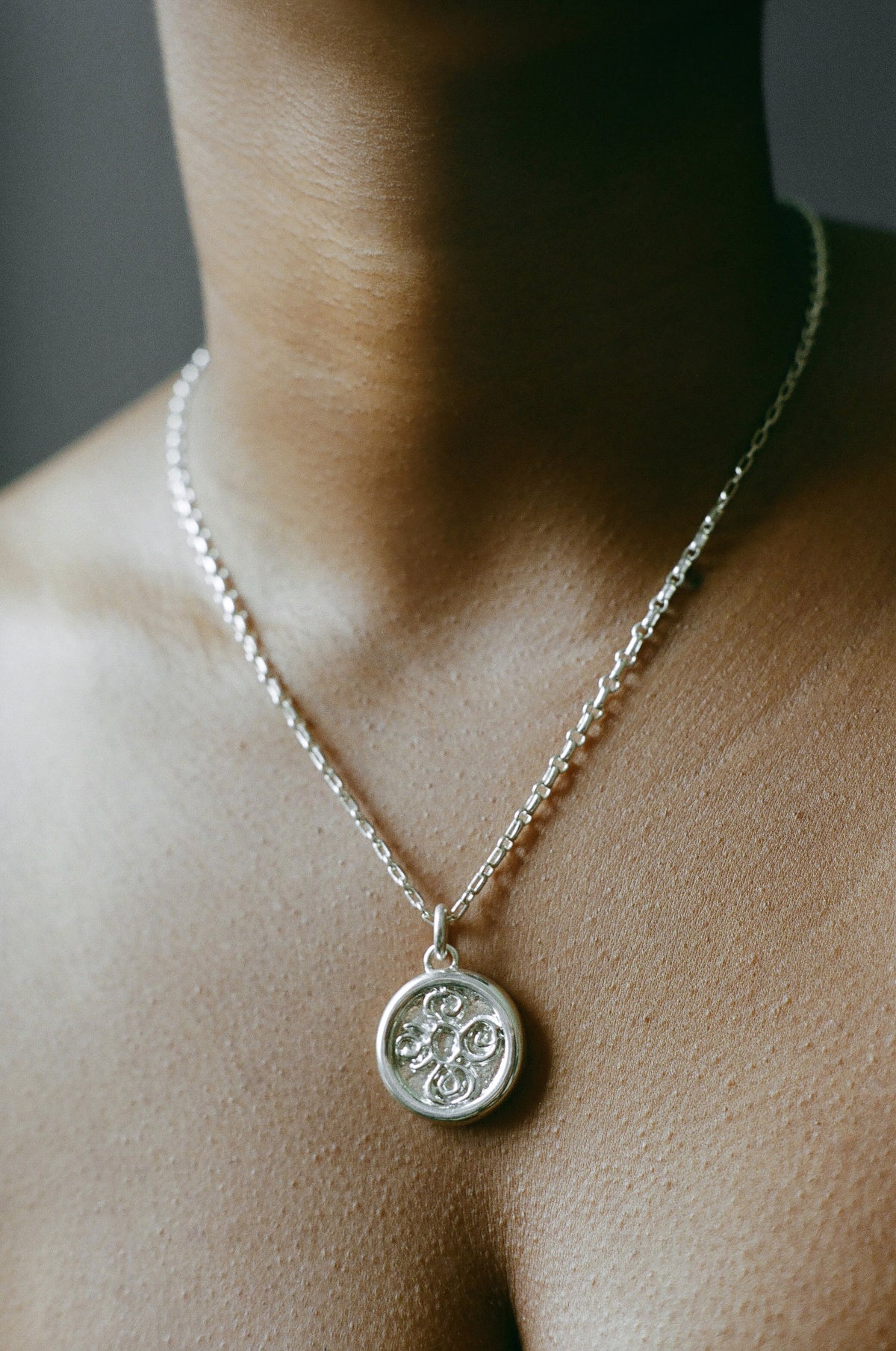 Model wearing AMS x LL Silver Seasons Pendant