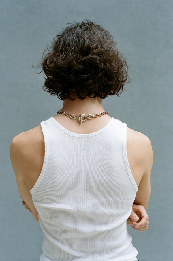 Back view of a person wearing the Laura Lombardi Silver Portrait chain necklace with a toggle clasp at the nape of the neck.