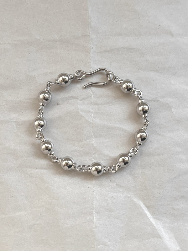 Laura Lombardi Silver Suona beaded bracelet on white paper background.
