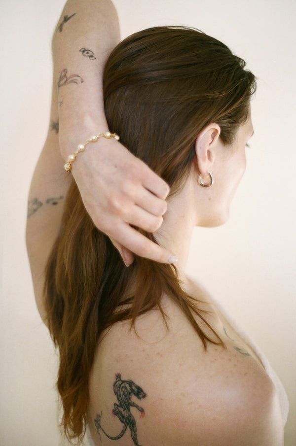 Model wearing Laura Lombardi gold Suona Bracelet