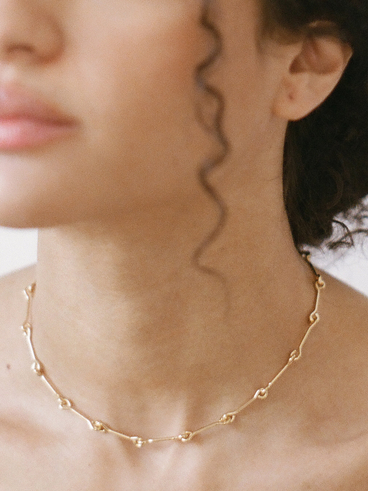 Model wearing Laura Lombardi gold Treccia Necklace